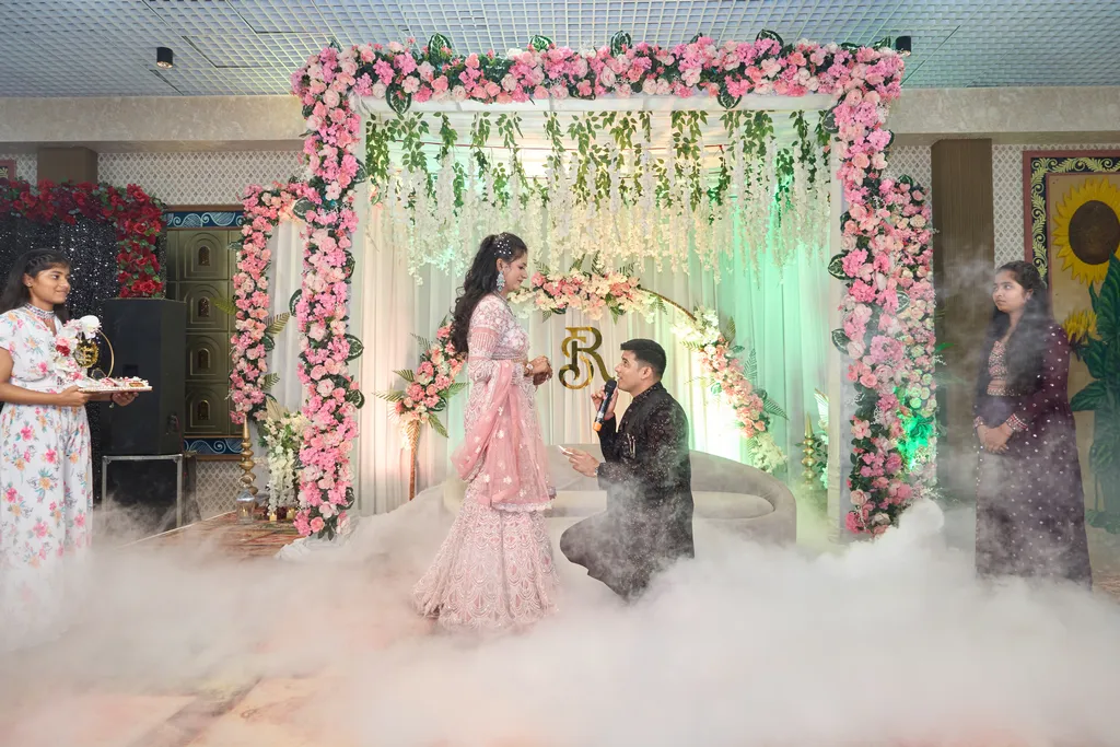 Sonu proposing to Rashmi on the floral stage at their Gokul Dham Lawn Varanasi engagement by The WeddingShoot